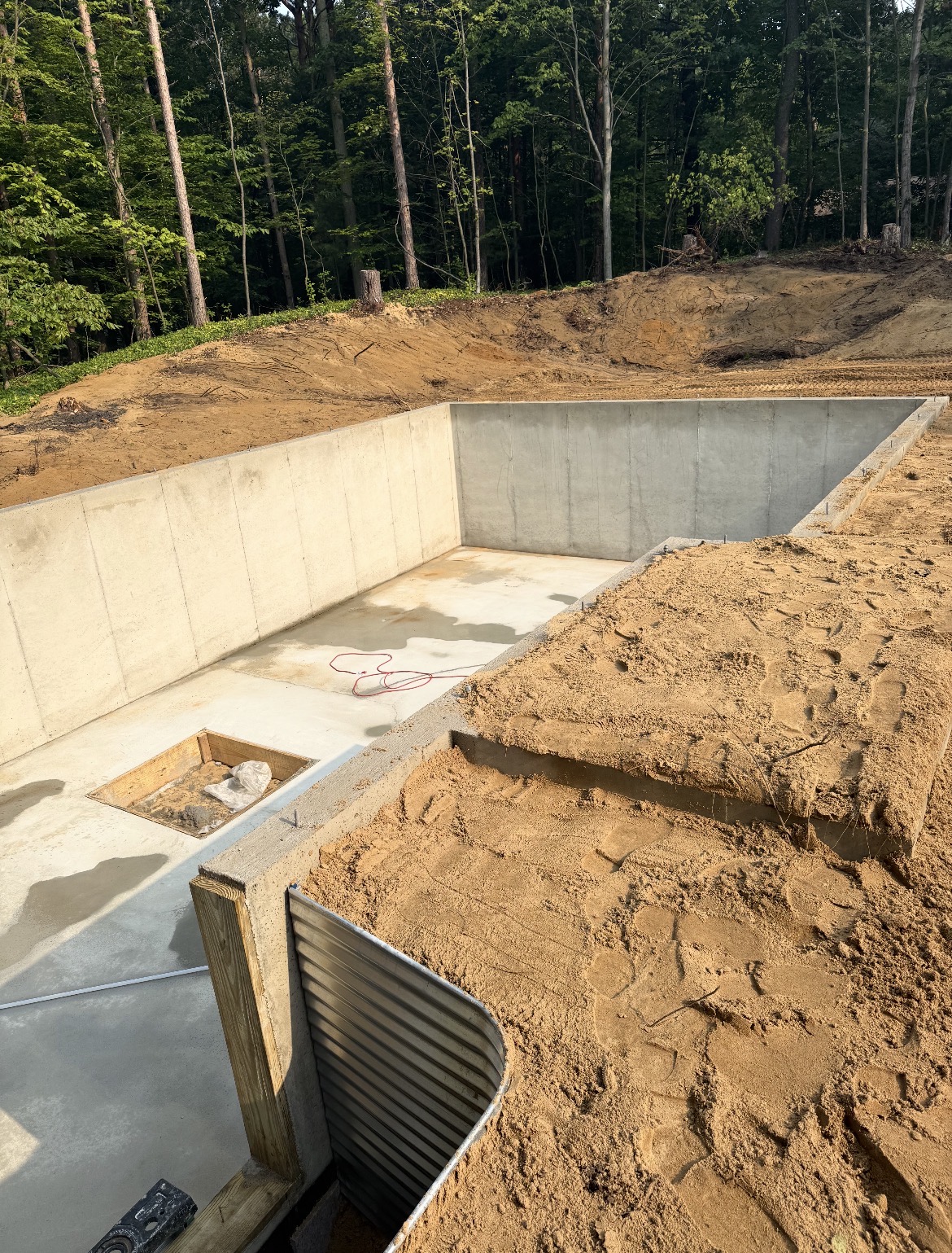 Poured concrete foundation walls on a wooded lot