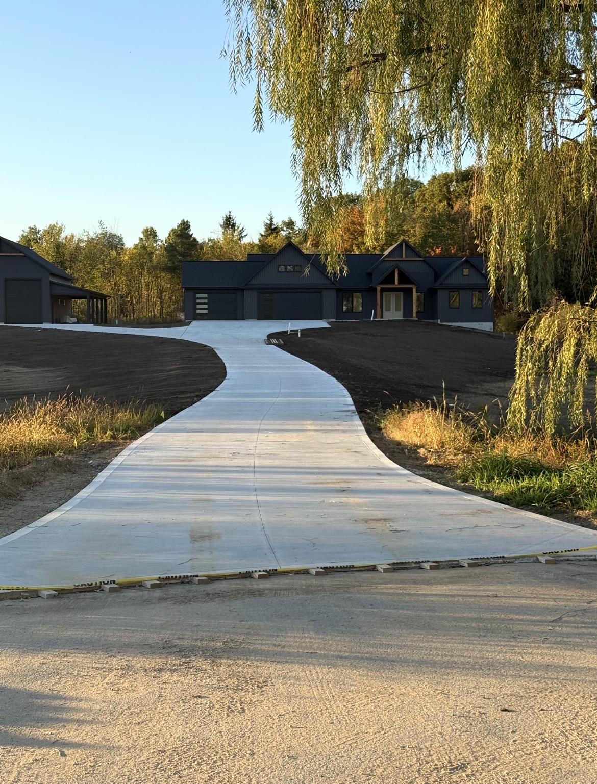 Finished concrete driveway leading to a new home