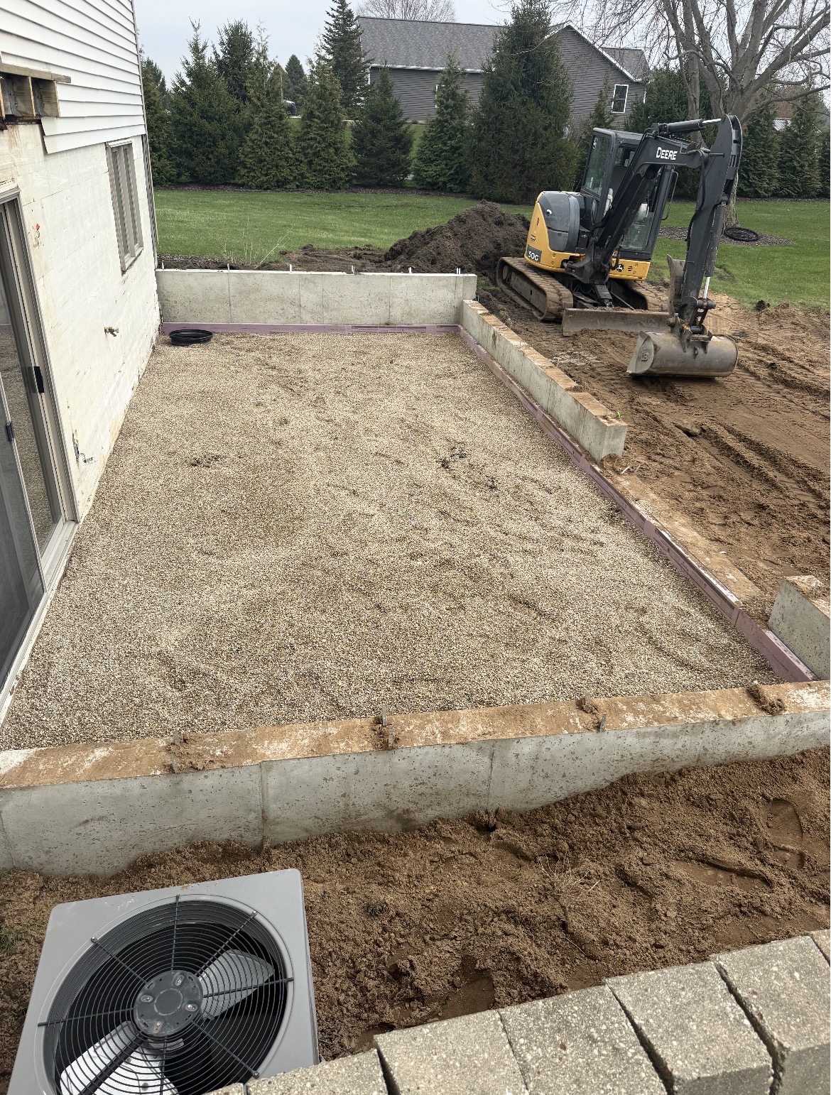 Gravel patio sub-base prepped with mini excavator